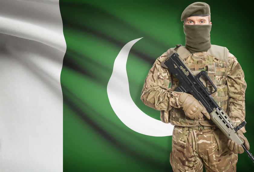 48652117 - soldier holding machine gun with national flag on background - pakistan