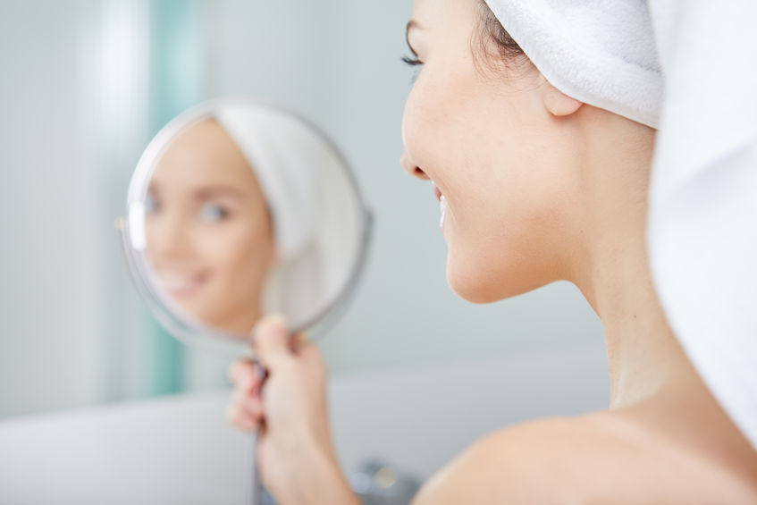 51686264 - face of young beautiful healthy woman and reflection in the mirror