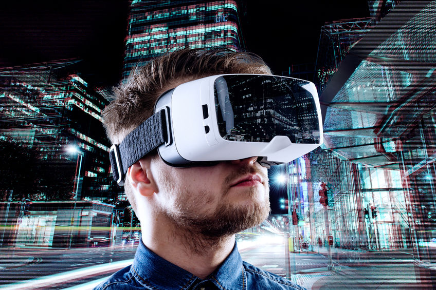 53460574 - man wearing virtual reality goggles against illuminated night city