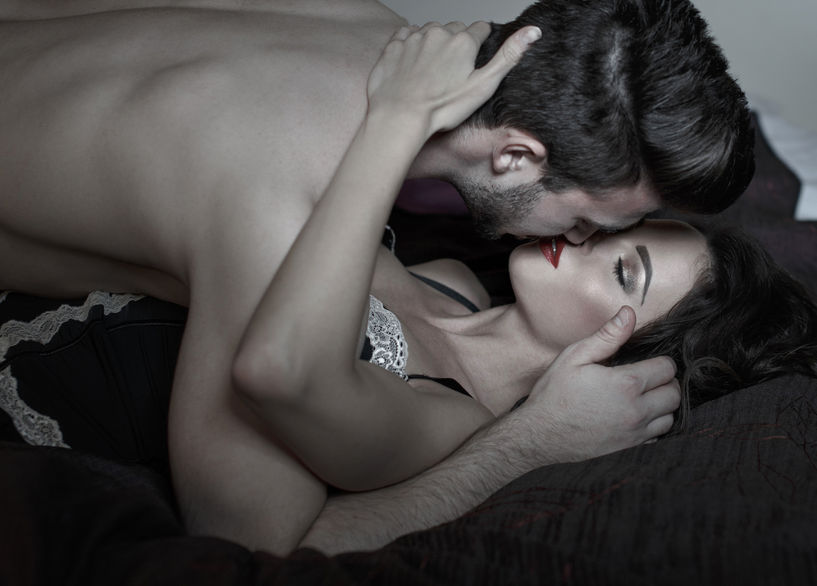 73348971 - passionate couple kissing in bed at night