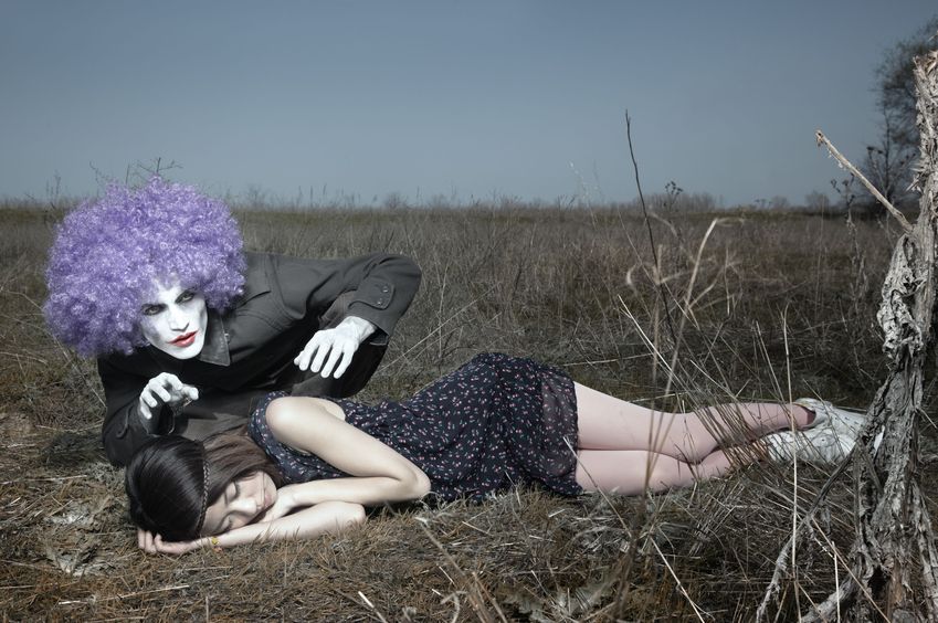 7670778 - sleeping girl outdoors and crazy maniac clown touching her shirt. artistic colors added