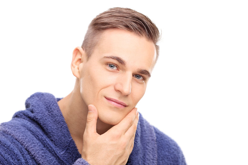 42870574 - studio shot of a young man checking the skin on his face isolated on white background