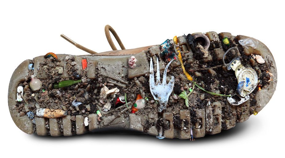 45153424 - sole of the shoe with dirt and garbage, the theme of ecology