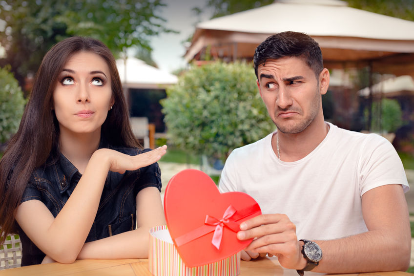 51897322 - girl refusing heart shaped gift from her boyfriend