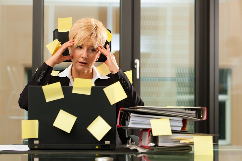 11193721 - a woman has stress in the office - multitasking and time management