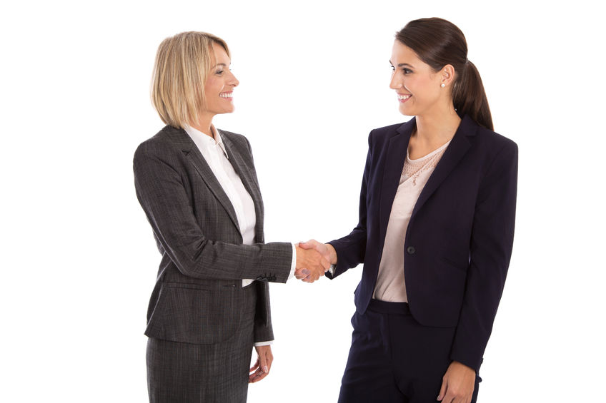 33450884 - team: two smiling isolated business woman shaking hands wearing business outfit