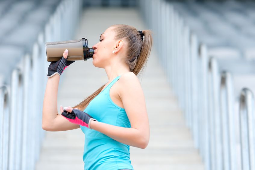 39503640 - portrait of healthy fitness girl drinking protein shake. woman drinking sports nutrition beverage while working out