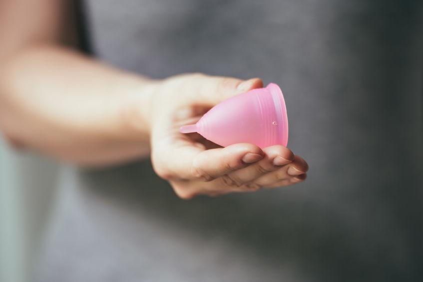 41238774 - young woman hand holding menstrual cup