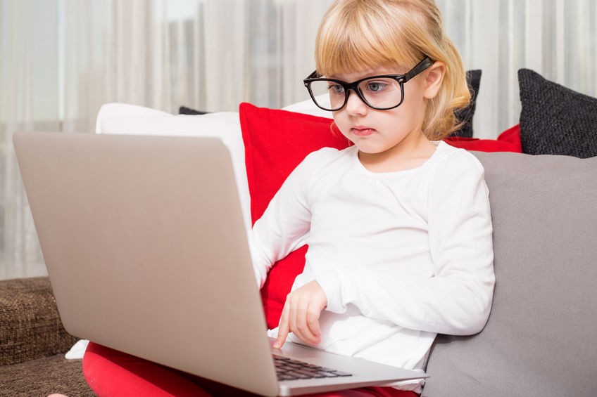 51844818 - little girl with glasses using modern technology