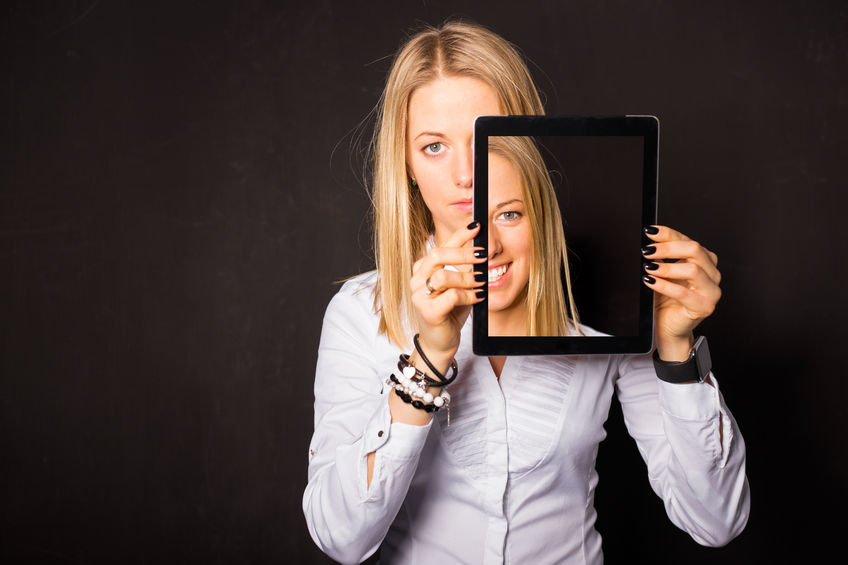 52546378 - woman standing with tablet in her hands