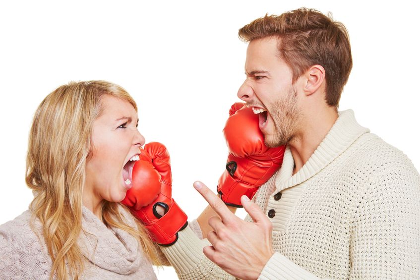 16979723 - screaming angry couple fighting with red boxing gloves
