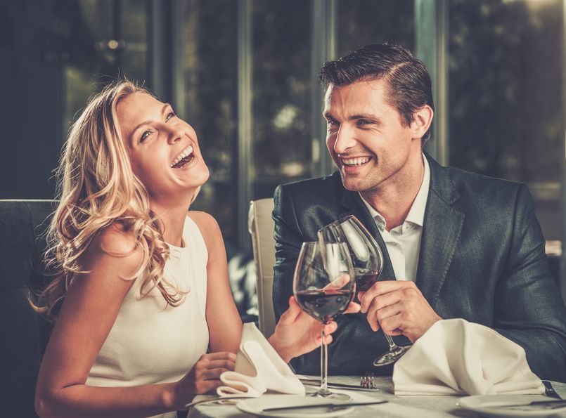29540051 - cheerful couple in a restaurant with glasses of red wine