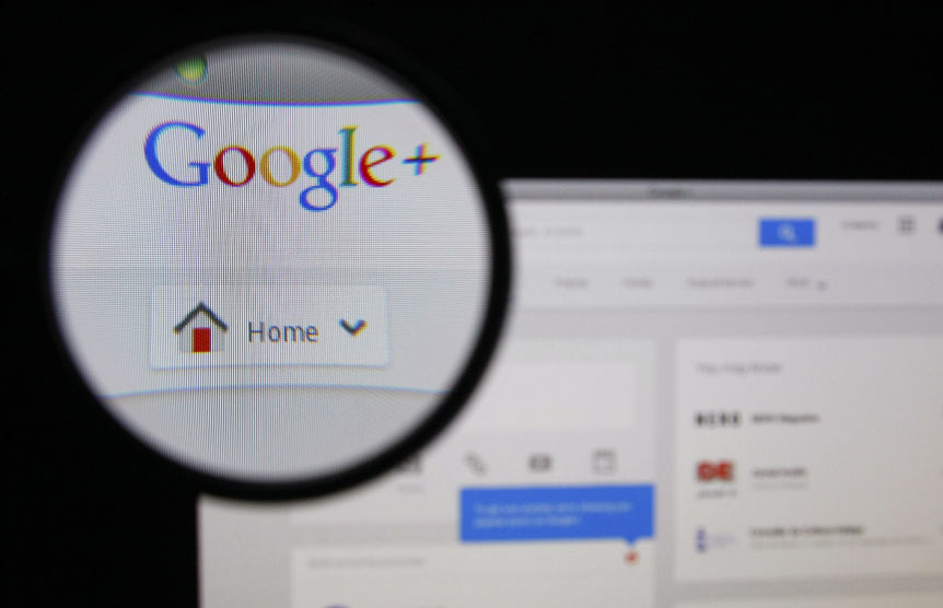 34778272 - lisbon - january 14, 2014: photo of google+ homepage on a monitor screen through a magnifying glass.