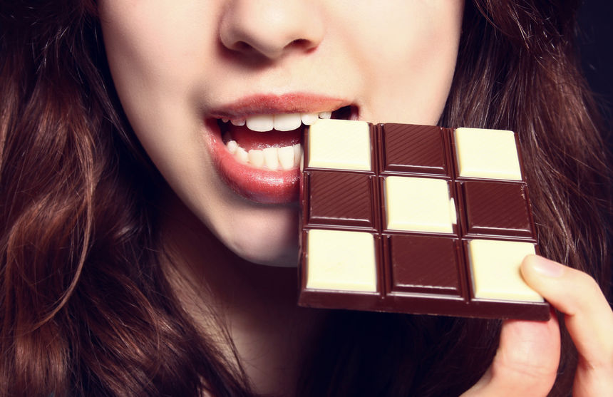 43271048 - closeup of woman eating chocolate