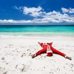 23321703 – santa claus on beach relaxing, enjoying summer