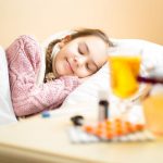41681422 – portrait of sick girl in woolen sweater lying in bed