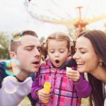 47410070 – beautiful young family enjoying their time at fun fair