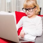 51844818 – little girl with glasses using modern technology