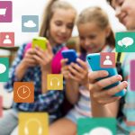 73726941 – elementary school students with smartphones