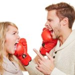 16979723 – screaming angry couple fighting with red boxing gloves
