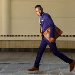 53356672 – full length portrait of young businessman running on city street
