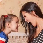 68507388 – young mother and her little daughter make each other terrible faces