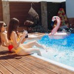 Girls on summer party in the swimming pool