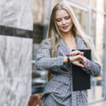 stylish-businesswoman-looking-watch